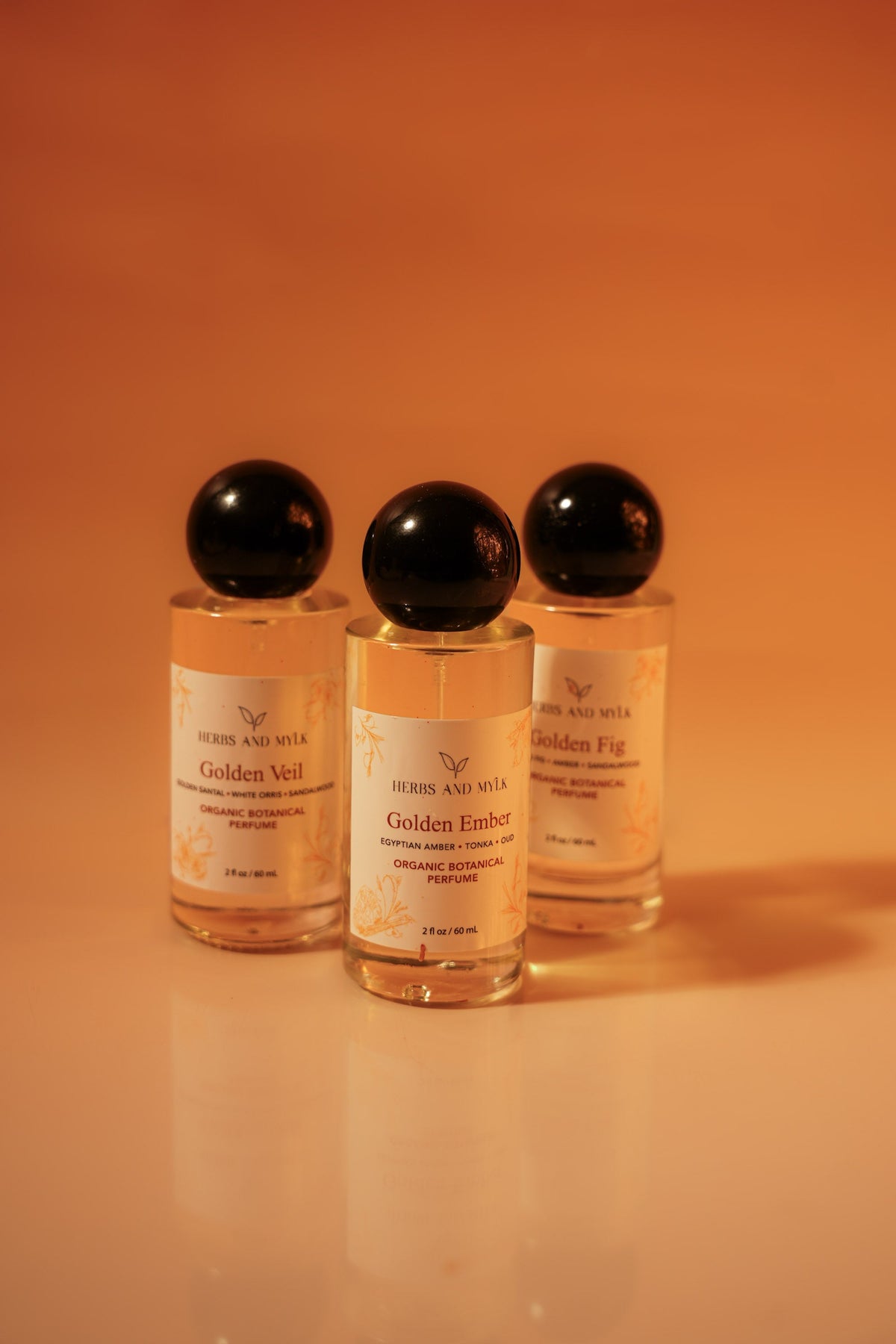 Golden Perfume Trio bottles arranged, Golden Veil Golden Fig Golden Ember